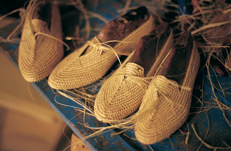 Artisan-crafted woven shoes displayed on a workbench in Esauira, Morocco.