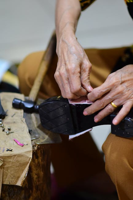 Handcrafting leather shoes with precision in a workshop setting, highlighting traditional methods.